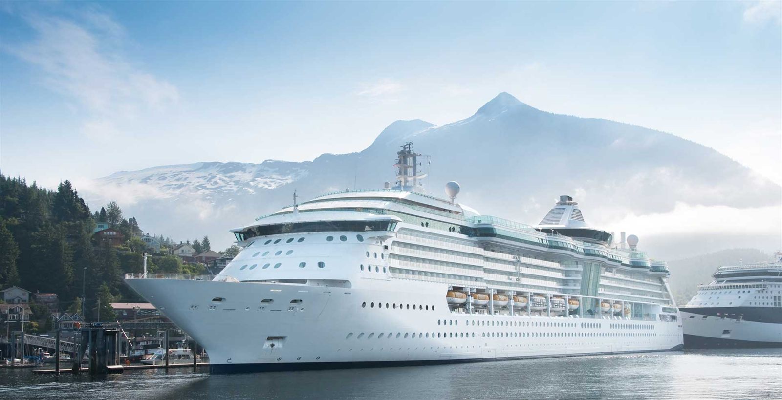 Cruise ship beneath snow-capped mountains